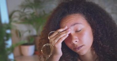 Shot of an attractive young african woman sitting alone and feeling stressed while using her computer to work from home. High quality 4k footage