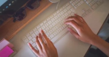 Cropped shot of an young african woman typing on a keyboardto work from home. High quality 4k footage