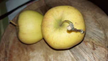 Ahşap servis tabağında elmalar. Organik meyve. Hasattan sonra çiğ elma. Meyveler vitamin ve minerallerle doludur. Doğal bir diş fırçası gibi. Tatlı ve ekşi olabilirler. Vejetaryen yemeği. Vejetaryen yemeği.