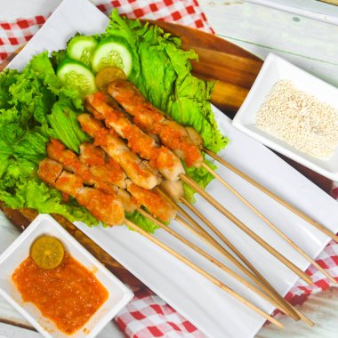 Sate Taichan, kızarmış tavuk, fıstık sosu ve soya sosu olmadan. Tabakta sambal (acı sos) ile servis edilir. Seçili odak.