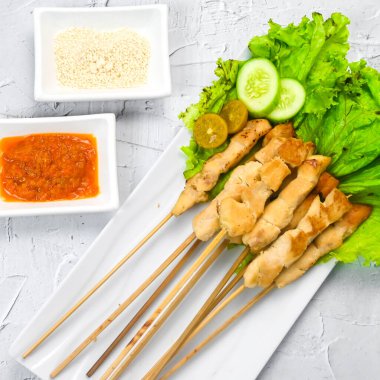 Sate Taichan, kızarmış tavuk, fıstık sosu ve soya sosu olmadan. Tabakta sambal (acı sos) ile servis edilir. Seçili odak.