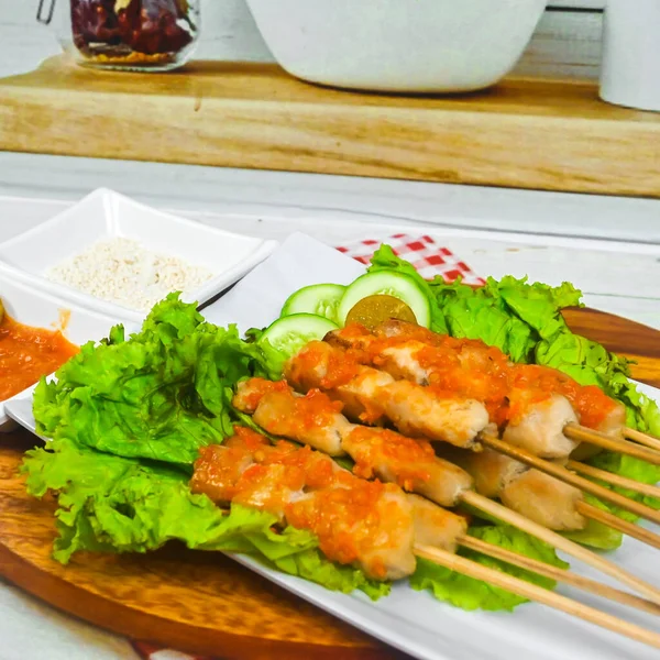 Sate Taichan, Grilled Chicken Satay without peanut sauce or soy sauce. Served on plate with sambal (chilli sauce). Selected focus.