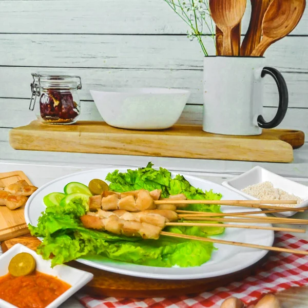 Sate Taichan, Grilled Chicken Satay without peanut sauce or soy sauce. Served on plate with sambal (chilli sauce). Selected focus.