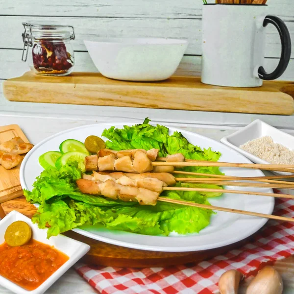 Sate Taichan, Grilled Chicken Satay without peanut sauce or soy sauce. Served on plate with sambal (chilli sauce). Selected focus.