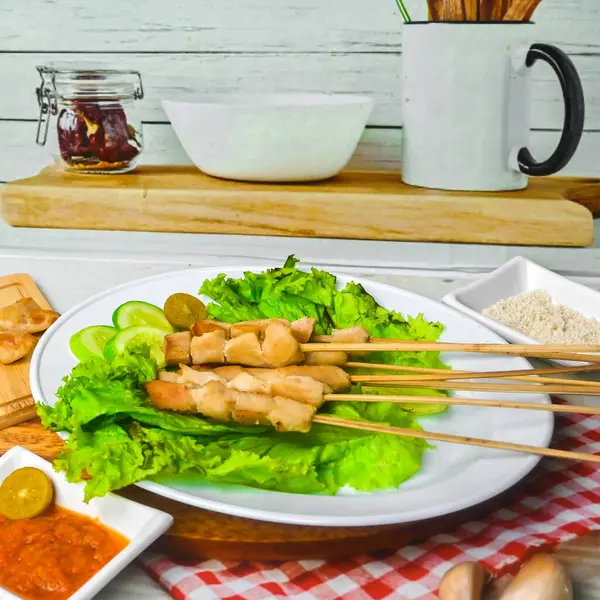 Sate Taichan, Grilled Chicken Satay without peanut sauce or soy sauce. Served on plate with sambal (chilli sauce). Selected focus.