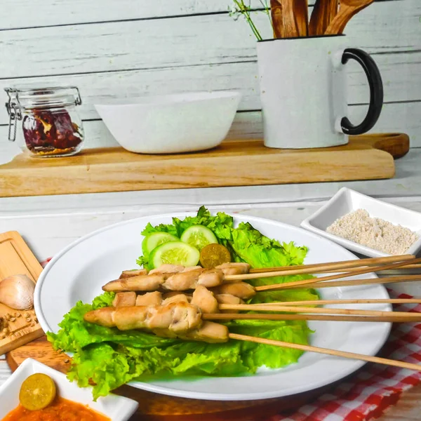 Sate Taichan, Grilled Chicken Satay without peanut sauce or soy sauce. Served on plate with sambal (chilli sauce). Selected focus.