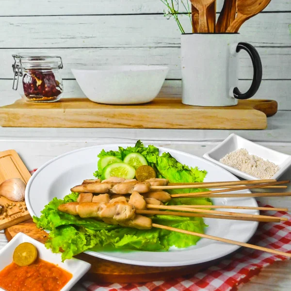 Sate Taichan, Grilled Chicken Satay without peanut sauce or soy sauce. Served on plate with sambal (chilli sauce). Selected focus.