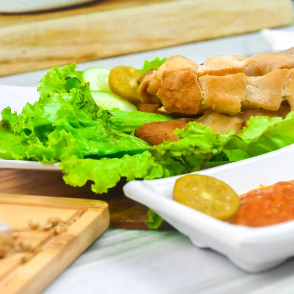 Sate Taichan, Grilled Chicken Satay without peanut sauce or soy sauce. Served on plate with sambal (chilli sauce). Selected focus.