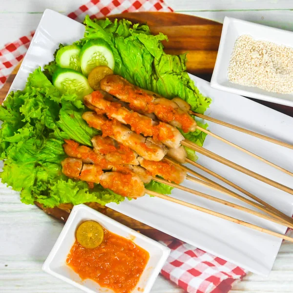Sate Taichan, Grilled Chicken Satay without peanut sauce or soy sauce. Served on plate with sambal (chilli sauce). Selected focus.