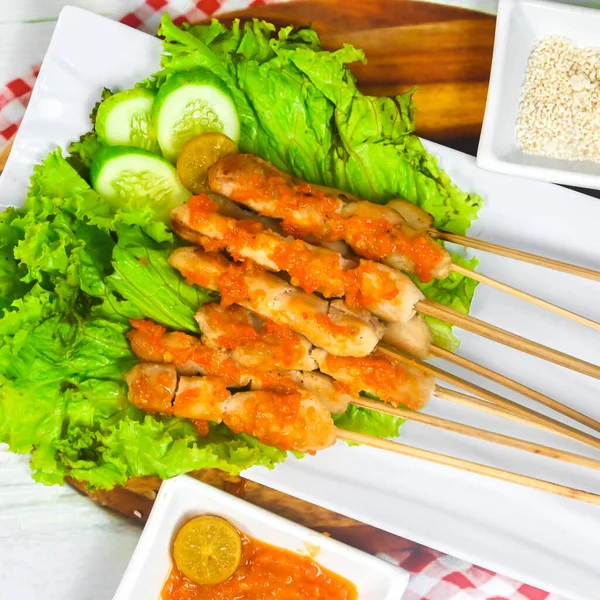 Sate Taichan, Grilled Chicken Satay without peanut sauce or soy sauce. Served on plate with sambal (chilli sauce). Selected focus.