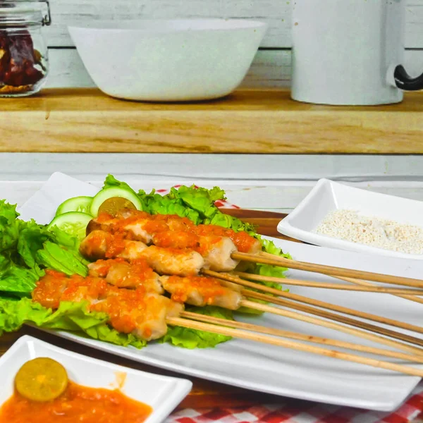 Sate Taichan, Grilled Chicken Satay without peanut sauce or soy sauce. Served on plate with sambal (chilli sauce). Selected focus.
