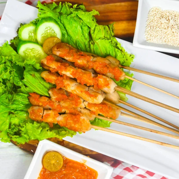 Sate Taichan, Grilled Chicken Satay without peanut sauce or soy sauce. Served on plate with sambal (chilli sauce). Selected focus.