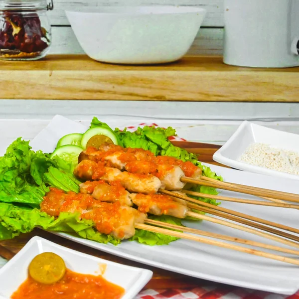 Sate Taichan, Grilled Chicken Satay without peanut sauce or soy sauce. Served on plate with sambal (chilli sauce). Selected focus.