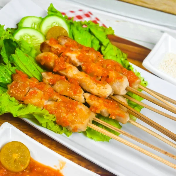 Sate Taichan, Grilled Chicken Satay without peanut sauce or soy sauce. Served on plate with sambal (chilli sauce). Selected focus.