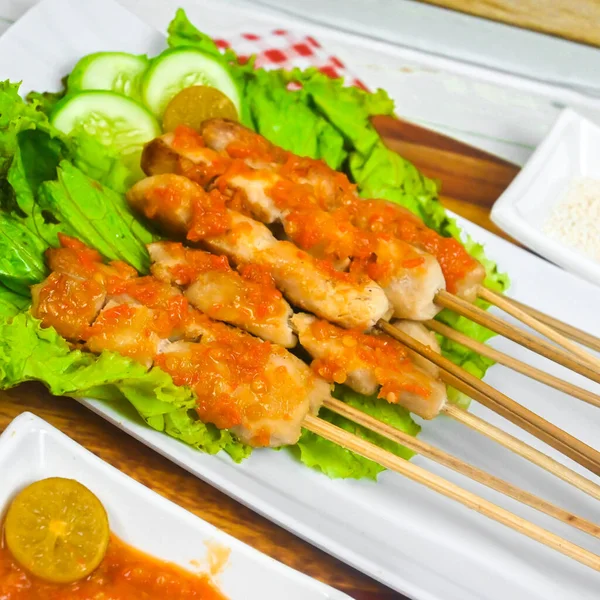 Sate Taichan, Grilled Chicken Satay without peanut sauce or soy sauce. Served on plate with sambal (chilli sauce). Selected focus.