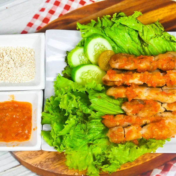 Sate Taichan, Grilled Chicken Satay without peanut sauce or soy sauce. Served on plate with sambal (chilli sauce). Selected focus.