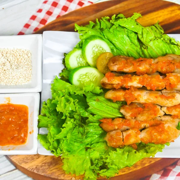 Sate Taichan, Grilled Chicken Satay without peanut sauce or soy sauce. Served on plate with sambal (chilli sauce). Selected focus.