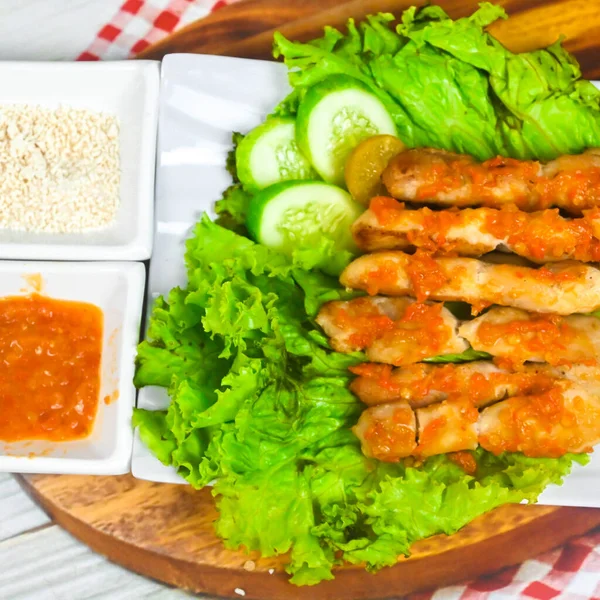 Sate Taichan, Grilled Chicken Satay without peanut sauce or soy sauce. Served on plate with sambal (chilli sauce). Selected focus.