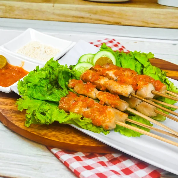 Sate Taichan, Grilled Chicken Satay without peanut sauce or soy sauce. Served on plate with sambal (chilli sauce). Selected focus.