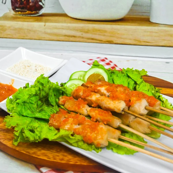 Sate Taichan, Grilled Chicken Satay without peanut sauce or soy sauce. Served on plate with sambal (chilli sauce). Selected focus.
