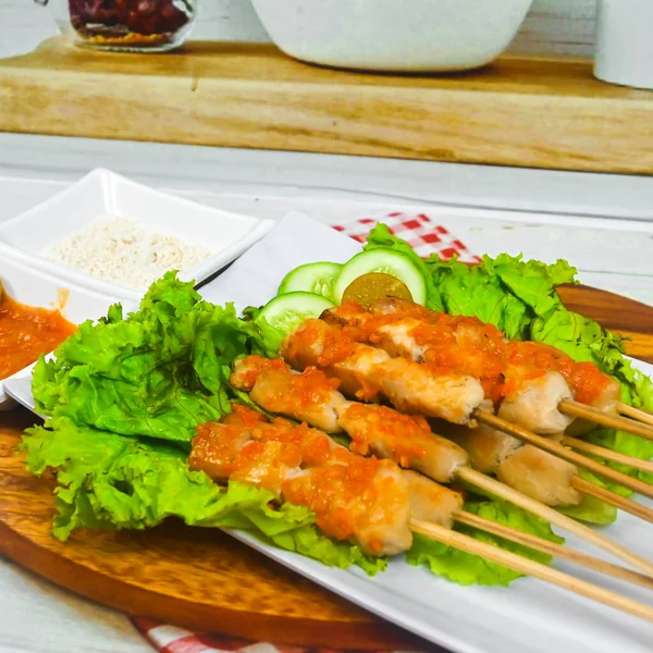 Sate Taichan, Grilled Chicken Satay without peanut sauce or soy sauce. Served on plate with sambal (chilli sauce). Selected focus.