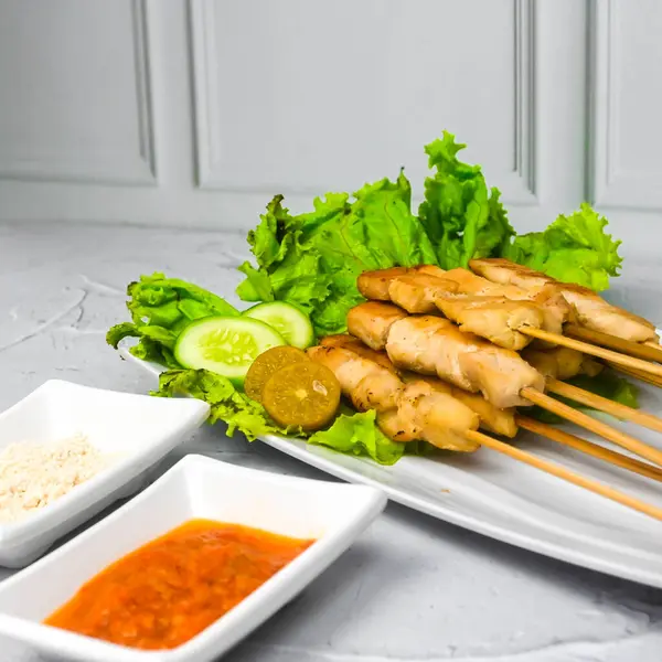 Sate Taichan, Grilled Chicken Satay without peanut sauce or soy sauce. Served on plate with sambal (chilli sauce). Selected focus.