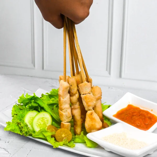 Sate Taichan, Grilled Chicken Satay without peanut sauce or soy sauce. Served on plate with sambal (chilli sauce). Selected focus.