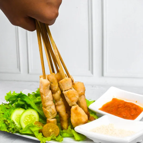 Sate Taichan, Grilled Chicken Satay without peanut sauce or soy sauce. Served on plate with sambal (chilli sauce). Selected focus.