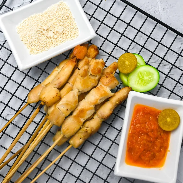 Sate Taichan, Grilled Chicken Satay without peanut sauce or soy sauce. Served on plate with sambal (chilli sauce). Selected focus.