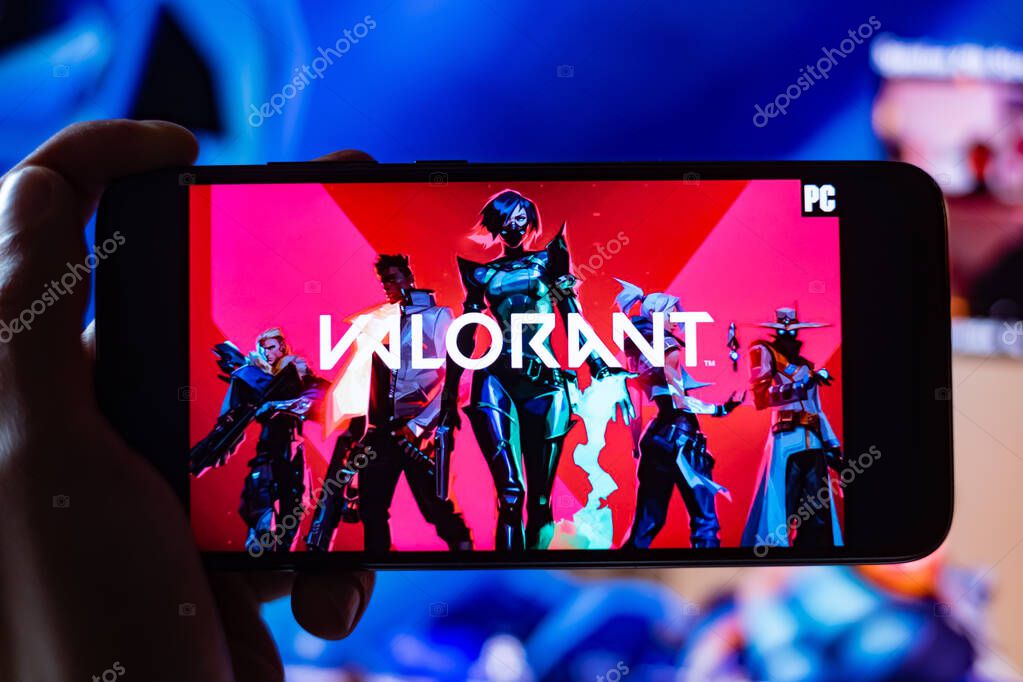 Valorant Game Title is shown on mobile phone Screen with twitch Streamer playing game in the background