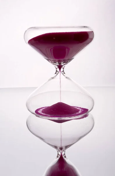 transparent glass clock of red sand photography made in photo studio