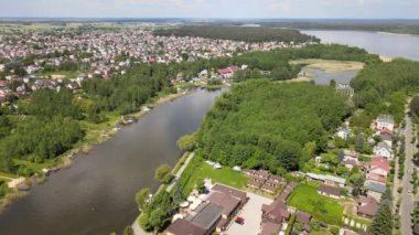 Panorama of Augustow from the drone.View of the Augustow Canal and cruise ships and sailboat sailing on it on a sunny summer day.