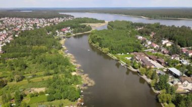 Panorama of Augustow from the drone.View of the Augustow Canal and cruise ships and sailboat sailing on it on a sunny summer day.