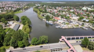Panorama of Augustow from the drone.View of the Augustow Canal and cruise ships and sailboat sailing on it on a sunny summer day.