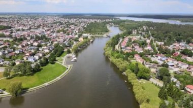 Panorama of Augustow from the drone.View of the Augustow Canal and cruise ships and sailboats sailing on it on a sunny summer day.