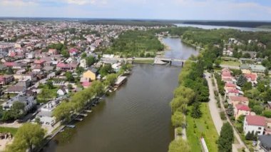 Panorama of Augustow from the drone.View of the Augustow Canal and cruise ships and sailboats sailing on it on a sunny summer day.