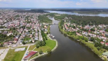 Panorama of Augustow from the drone.View of the Augustow Canal and cruise ships and sailboats sailing on it on a sunny summer day.
