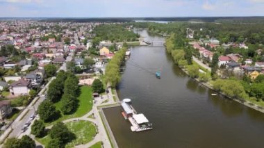 Panorama of Augustow from the drone.View of the Augustow Canal and cruise ships and sailboats sailing on it on a sunny summer day.