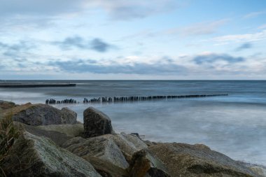 Baltic Sea-View of the breakwater and stones on the shore of the Baltic Sea in Kolobrzeg.