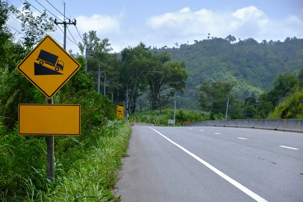 Driving safely on the road with warning signs on the way, along dangerous curves, and ramps, and driving carefully on highways and country roads.