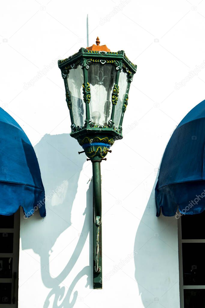 Lamp in street view on the background of buildings and a lantern