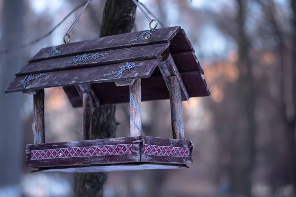 View of a hanging bird feeder decorated with ornaments