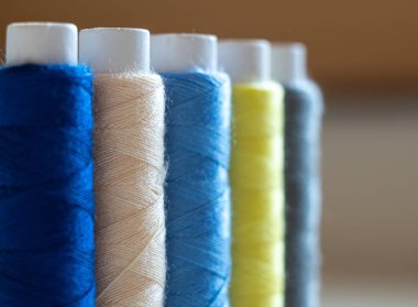 multi-colored threads on spools close-up