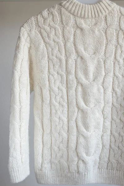 Children's warm white wool sweater isolated on white background.