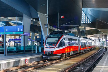 Vienna, Austria - winter 2022: A multi-section passenger train arrived at the platform of the central railway station. Austrian railway