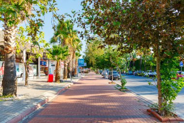 Kiris, Kemer, Turkey - Spring 2022: Deserted pedestrian sidewalk on one of the tourist streets. Shops with souvenirs. Lack of tourists. Tourist region of Antalya. Sunny weather.