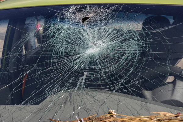 Closeup of car with broken windshield, Terrible dangerous car after a fatal accident. Broken windshield. A broken car with broken glass.