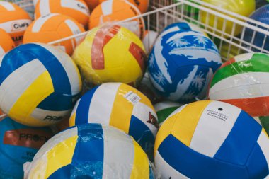 Footballs and volleyballs in the store. Sports department in the store.