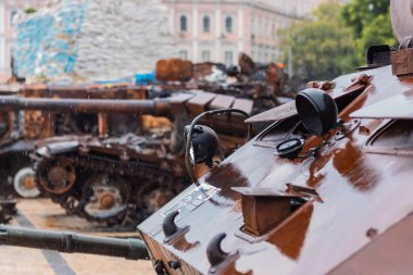 Destroyed Russian tank in the rain. Rusty broken military equipment in the rain.