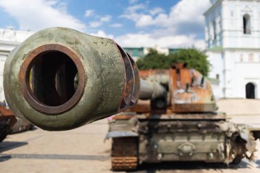 Destroyed Russian tank in the rain. Rusty broken military equipment. Ukraine in War.
